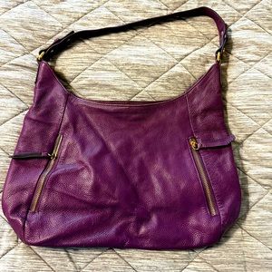 ORA DELPHINE purple handbag. A symbol of being free from financial abuse.